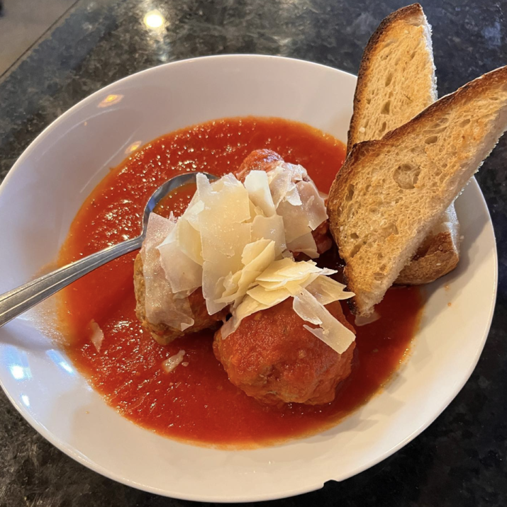 IL Bosco meatballs in red sauce with shaved parmesan and crostini