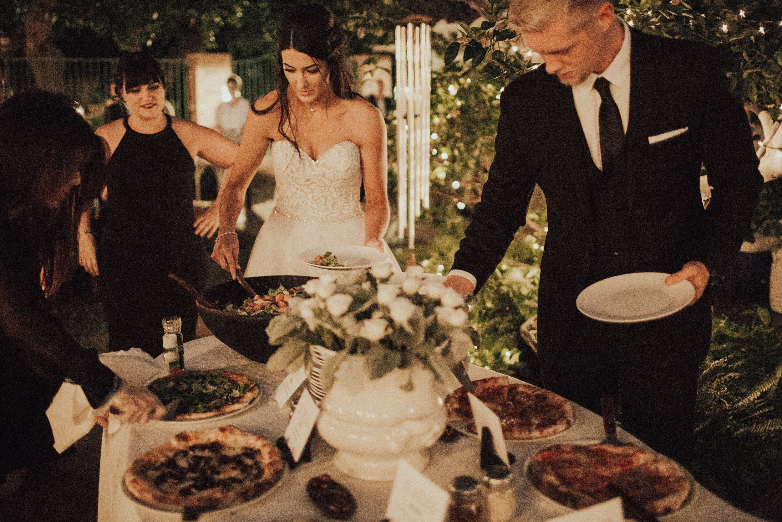 Guests enjoying IL Bosco pizza at a catered wedding